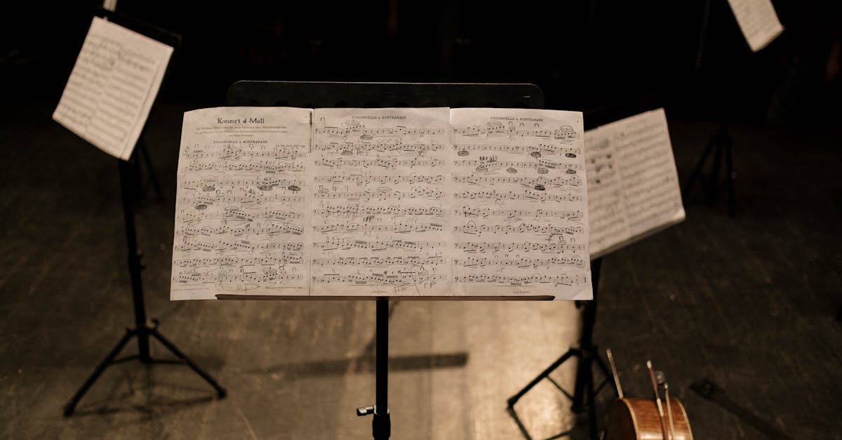 Close-up of sheet music on a stand in an empty music hall.